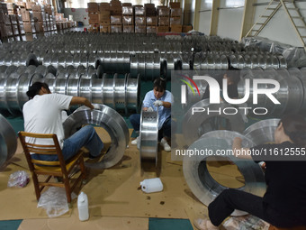 A worker cleans a tray at Pacific Special Mesh Industry Co., LTD in Fuyang, China, on September 27, 2024. (