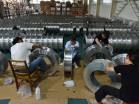 A worker cleans a tray at Pacific Special Mesh Industry Co., LTD in Fuyang, China, on September 27, 2024. (