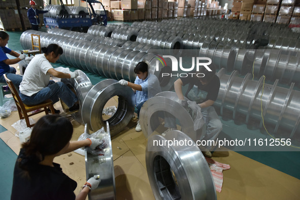 A worker cleans a tray at Pacific Special Mesh Industry Co., LTD in Fuyang, China, on September 27, 2024. 