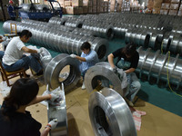 A worker cleans a tray at Pacific Special Mesh Industry Co., LTD in Fuyang, China, on September 27, 2024. (