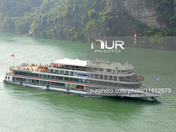 Tourists take a cruise to visit the Three Gorges of the Yangtze River on World Tourism Day in Yichang, China, on September 27, 2024. 