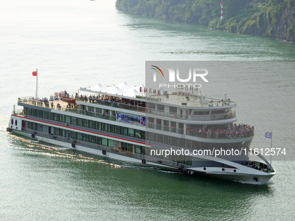 Tourists take a cruise to visit the Three Gorges of the Yangtze River on World Tourism Day in Yichang, China, on September 27, 2024. 