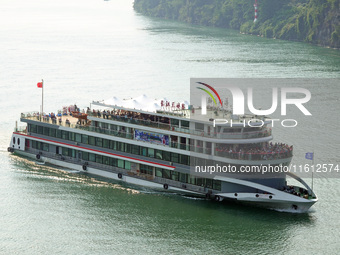 Tourists take a cruise to visit the Three Gorges of the Yangtze River on World Tourism Day in Yichang, China, on September 27, 2024. (