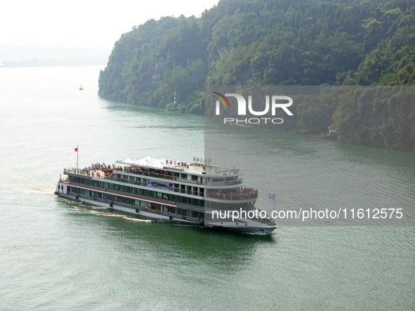 Tourists take a cruise to visit the Three Gorges of the Yangtze River on World Tourism Day in Yichang, China, on September 27, 2024. 