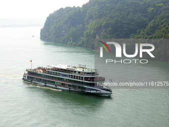 Tourists take a cruise to visit the Three Gorges of the Yangtze River on World Tourism Day in Yichang, China, on September 27, 2024. (