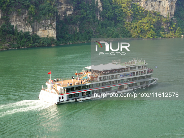 Tourists take a cruise to visit the Three Gorges of the Yangtze River on World Tourism Day in Yichang, China, on September 27, 2024. 