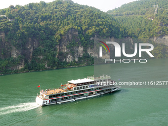 Tourists take a cruise to visit the Three Gorges of the Yangtze River on World Tourism Day in Yichang, China, on September 27, 2024. (