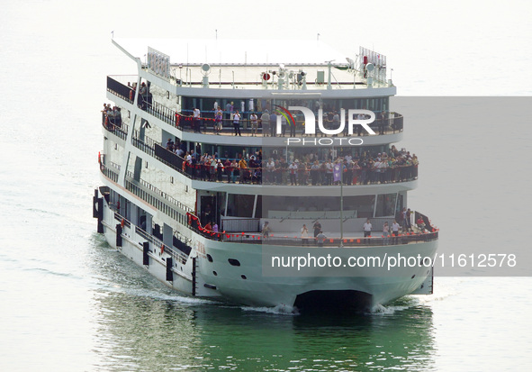 Tourists take a cruise to visit the Three Gorges of the Yangtze River on World Tourism Day in Yichang, China, on September 27, 2024. 