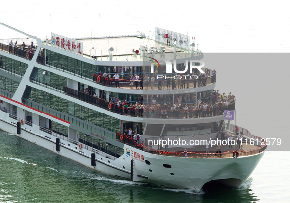 Tourists take a cruise to visit the Three Gorges of the Yangtze River on World Tourism Day in Yichang, China, on September 27, 2024. 