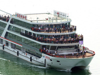 Tourists take a cruise to visit the Three Gorges of the Yangtze River on World Tourism Day in Yichang, China, on September 27, 2024. (