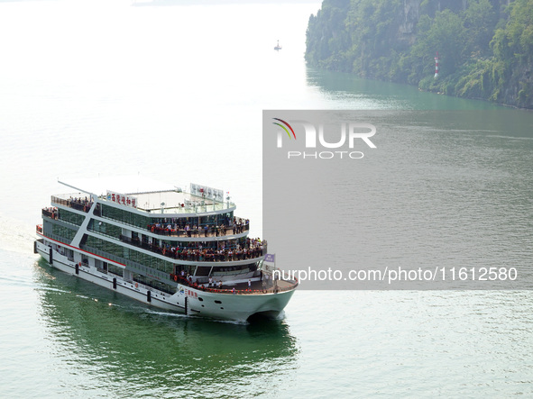 Tourists take a cruise to visit the Three Gorges of the Yangtze River on World Tourism Day in Yichang, China, on September 27, 2024. 