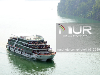 Tourists take a cruise to visit the Three Gorges of the Yangtze River on World Tourism Day in Yichang, China, on September 27, 2024. (