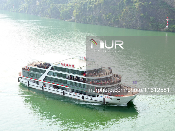 Tourists take a cruise to visit the Three Gorges of the Yangtze River on World Tourism Day in Yichang, China, on September 27, 2024. 