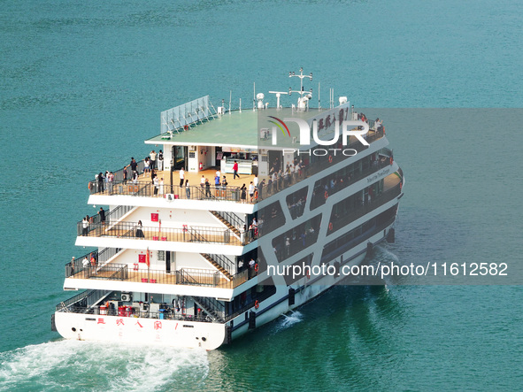 Tourists take a cruise to visit the Three Gorges of the Yangtze River on World Tourism Day in Yichang, China, on September 27, 2024. 