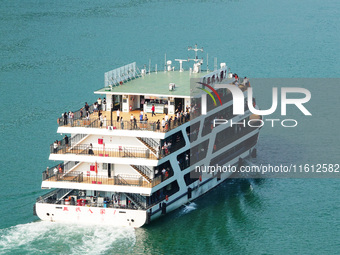 Tourists take a cruise to visit the Three Gorges of the Yangtze River on World Tourism Day in Yichang, China, on September 27, 2024. (