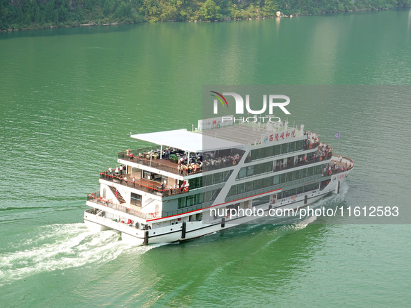 Tourists take a cruise to visit the Three Gorges of the Yangtze River on World Tourism Day in Yichang, China, on September 27, 2024. 