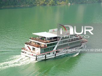 Tourists take a cruise to visit the Three Gorges of the Yangtze River on World Tourism Day in Yichang, China, on September 27, 2024. (