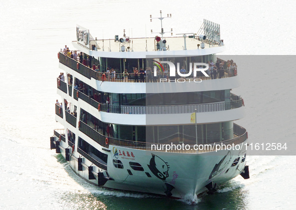 Tourists take a cruise to visit the Three Gorges of the Yangtze River on World Tourism Day in Yichang, China, on September 27, 2024. 