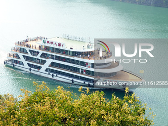 Tourists take a cruise to visit the Three Gorges of the Yangtze River on World Tourism Day in Yichang, China, on September 27, 2024. (