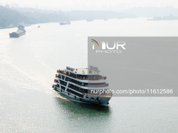 Tourists take a cruise to visit the Three Gorges of the Yangtze River on World Tourism Day in Yichang, China, on September 27, 2024. 