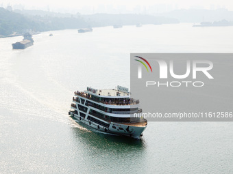 Tourists take a cruise to visit the Three Gorges of the Yangtze River on World Tourism Day in Yichang, China, on September 27, 2024. (