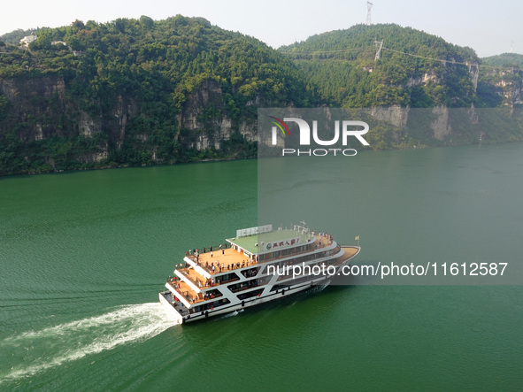 Tourists take a cruise to visit the Three Gorges of the Yangtze River on World Tourism Day in Yichang, China, on September 27, 2024. 