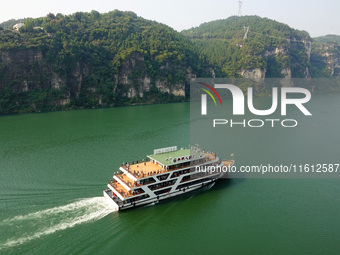 Tourists take a cruise to visit the Three Gorges of the Yangtze River on World Tourism Day in Yichang, China, on September 27, 2024. (