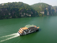 Tourists take a cruise to visit the Three Gorges of the Yangtze River on World Tourism Day in Yichang, China, on September 27, 2024. (