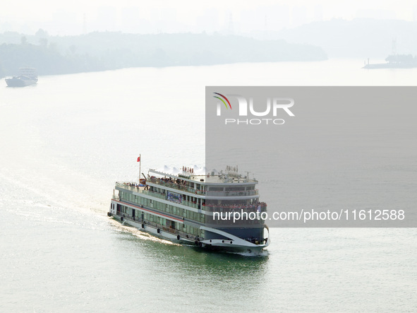 Tourists take a cruise to visit the Three Gorges of the Yangtze River on World Tourism Day in Yichang, China, on September 27, 2024. 