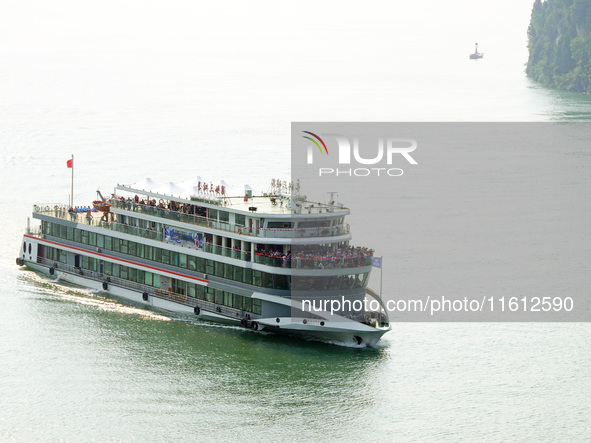 Tourists take a cruise to visit the Three Gorges of the Yangtze River on World Tourism Day in Yichang, China, on September 27, 2024. 