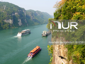 Tourists take a cruise to visit the Three Gorges of the Yangtze River on World Tourism Day in Yichang, China, on September 27, 2024. (