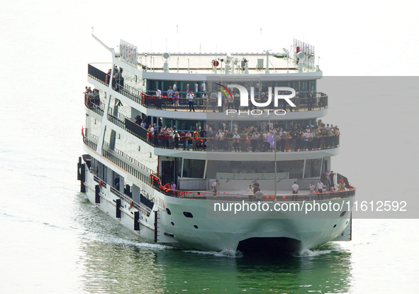 Tourists take a cruise to visit the Three Gorges of the Yangtze River on World Tourism Day in Yichang, China, on September 27, 2024. 