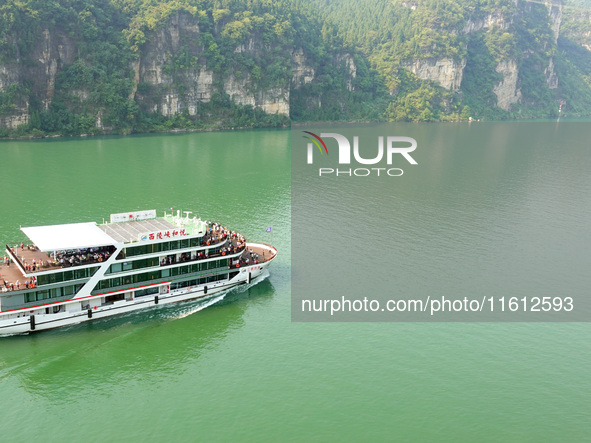 Tourists take a cruise to visit the Three Gorges of the Yangtze River on World Tourism Day in Yichang, China, on September 27, 2024. 