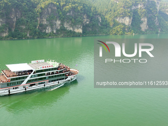 Tourists take a cruise to visit the Three Gorges of the Yangtze River on World Tourism Day in Yichang, China, on September 27, 2024. (