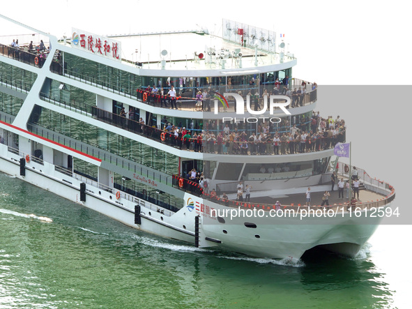 Tourists take a cruise to visit the Three Gorges of the Yangtze River on World Tourism Day in Yichang, China, on September 27, 2024. 