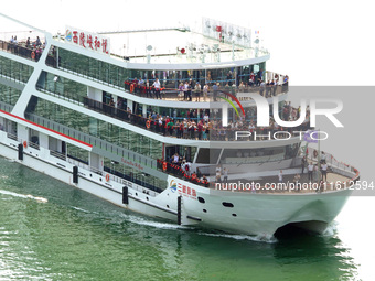 Tourists take a cruise to visit the Three Gorges of the Yangtze River on World Tourism Day in Yichang, China, on September 27, 2024. (