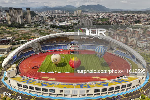 Hot air balloons and drones are displayed at the event of the China International Aircraft Design Challenge 2024 (Fujian Station) at the New...