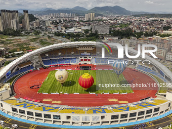 Hot air balloons and drones are displayed at the event of the China International Aircraft Design Challenge 2024 (Fujian Station) at the New...