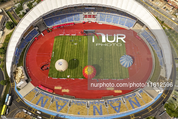 Hot air balloons and drones are displayed at the event of the China International Aircraft Design Challenge 2024 (Fujian Station) at the New...