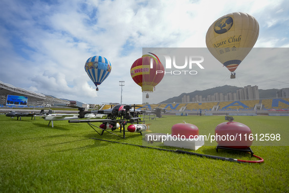 Hot air balloons and drones are displayed at the event of the China International Aircraft Design Challenge 2024 (Fujian Station) at the New...