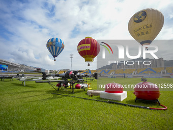 Hot air balloons and drones are displayed at the event of the China International Aircraft Design Challenge 2024 (Fujian Station) at the New...