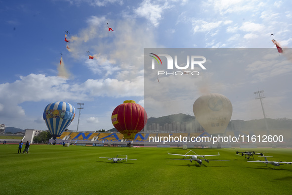 Drones perform at the event site of the China International Aircraft Design Challenge 2024 (Fujian Station) at the New Stadium in Nan'an, Fu...