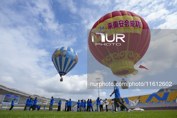 Aviation enthusiasts experience a hot air balloon ride at the event site of the 2024 China International Aircraft Design Challenge (Fujian S...