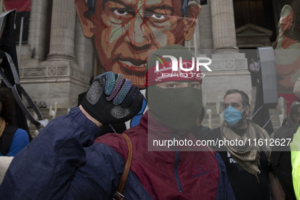 A pro-Palestinian demonstrator poses for photographs during a protest in Bryant Park, New York City, USA, on September 26, 2024. Hundreds ga...