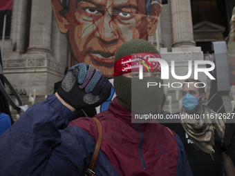 A pro-Palestinian demonstrator poses for photographs during a protest in Bryant Park, New York City, USA, on September 26, 2024. Hundreds ga...