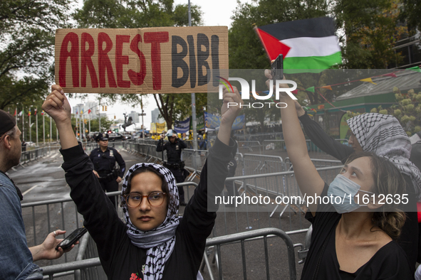 A pro-Palestinian demonstrator shows a sign with the words ''Arrest Bibi'' during a protest in front of the United Nations (UN) headquarters...