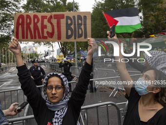 A pro-Palestinian demonstrator shows a sign with the words ''Arrest Bibi'' during a protest in front of the United Nations (UN) headquarters...