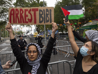 A pro-Palestinian demonstrator shows a sign with the words ''Arrest Bibi'' during a protest in front of the United Nations (UN) headquarters...