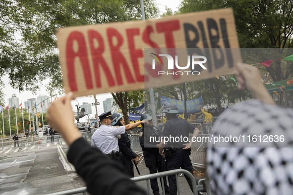 A pro-Palestinian demonstrator shows a sign with the words ''Arrest Bibi'' during a protest in front of the United Nations (UN) headquarters...