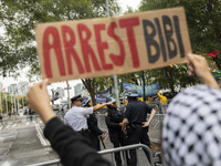 A pro-Palestinian demonstrator shows a sign with the words ''Arrest Bibi'' during a protest in front of the United Nations (UN) headquarters...